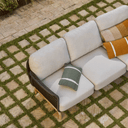 Outdoor sofa with cushions on a stone patio